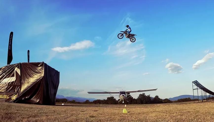 Freestyle MX Rider Jump His Dirt Bike Over A Flying Airplane